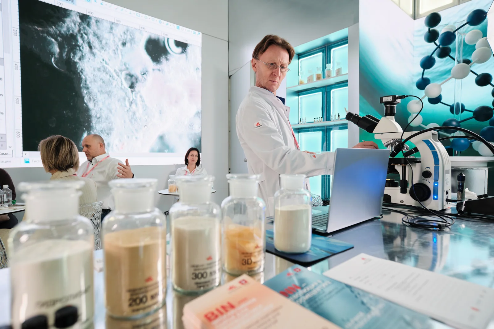 A microscope and demonstration screen at a workspace